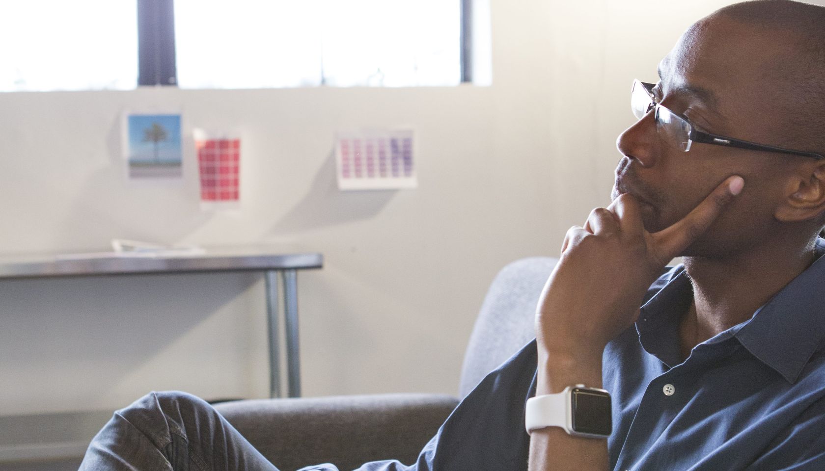 Mixed race businessman thinking in office