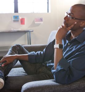 Mixed race businessman thinking in office