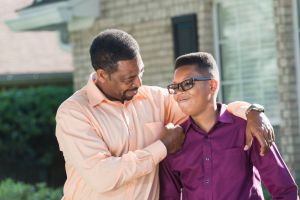 Proud African American father with teenage son