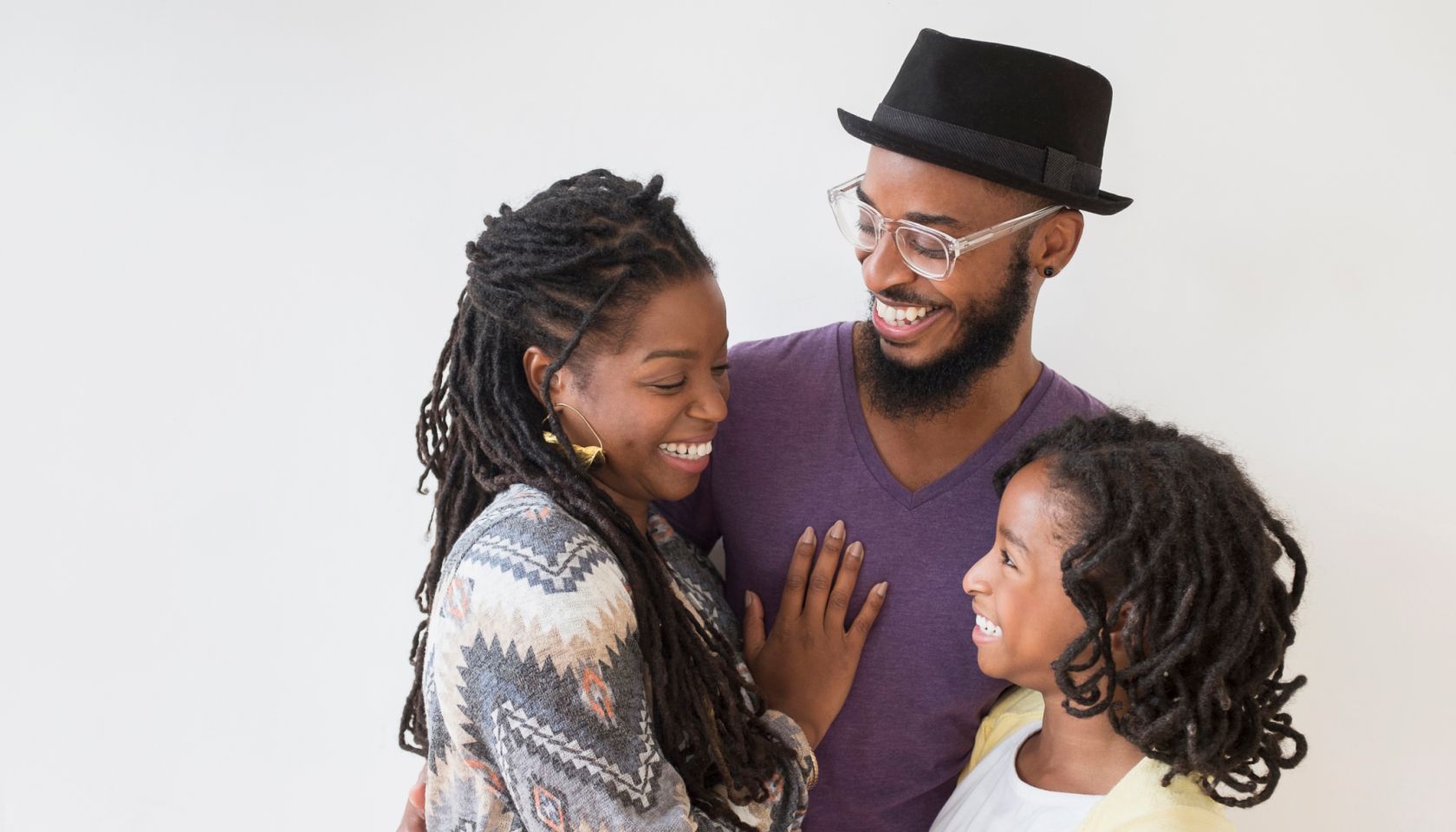 Smiling Black family hugging