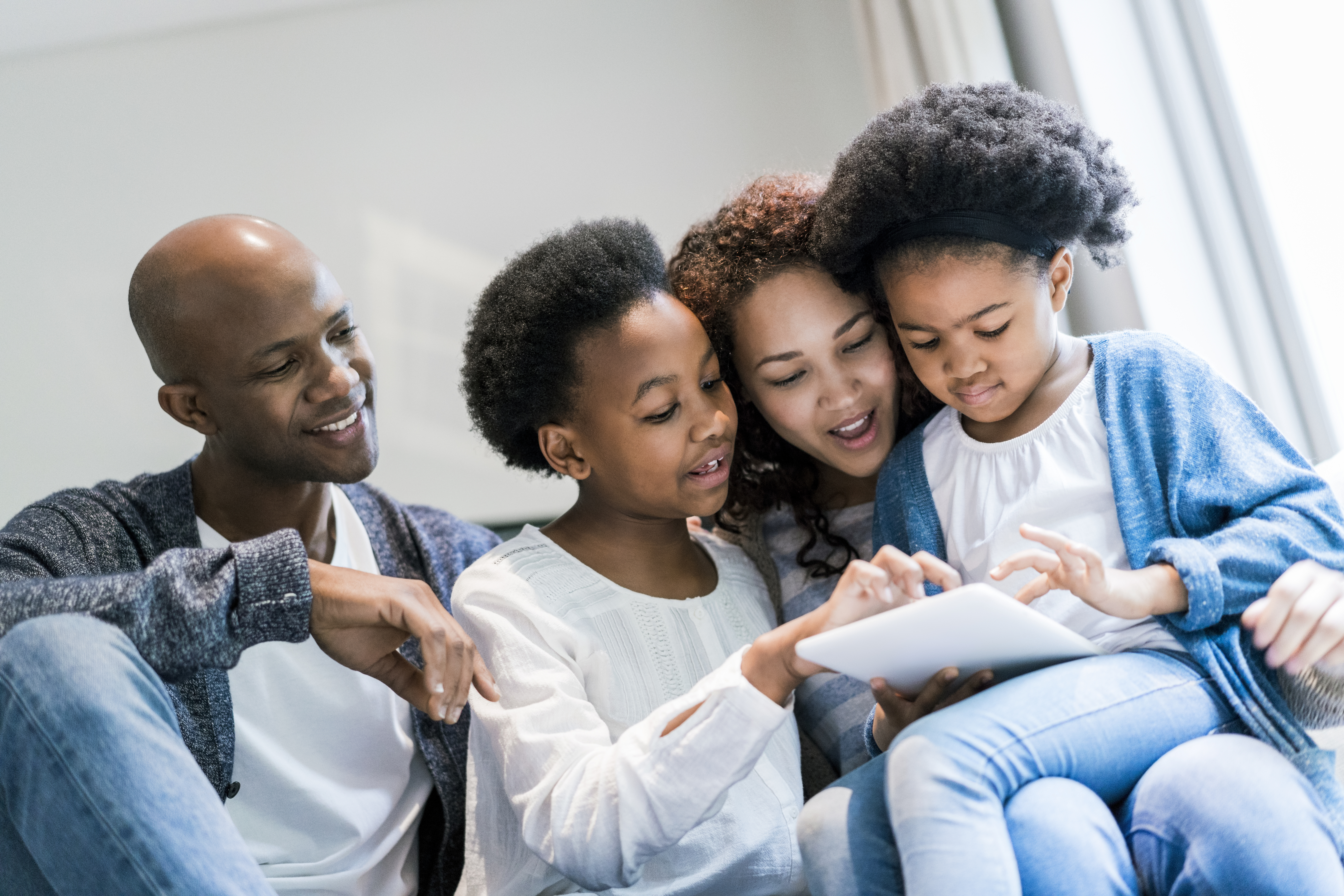 Happy family sitting on sofa at home